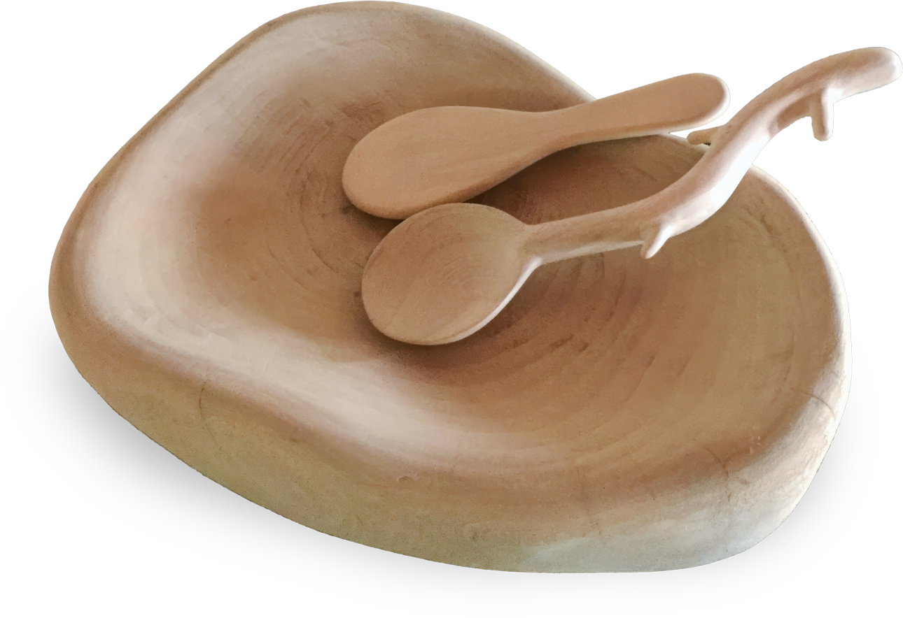 A smooth, light wooden bowl with an irregular, organic shape is shown with two matching wooden serving spoons resting inside, all having a natural, minimalist design. The bowl and spoons appear hand-crafted with visible grain patterns.