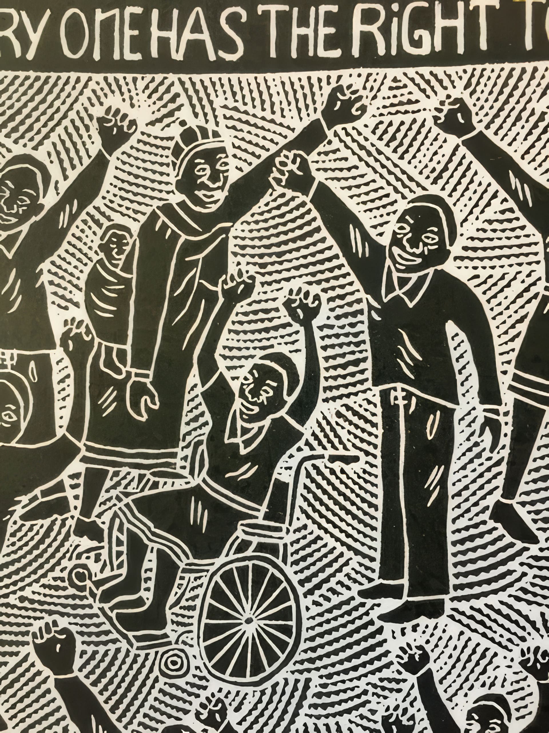 Black and white illustration of joyful people with raised arms, including a person in a wheelchair, celebrating together. The background features radiating lines and partially visible text at the top that reads: 