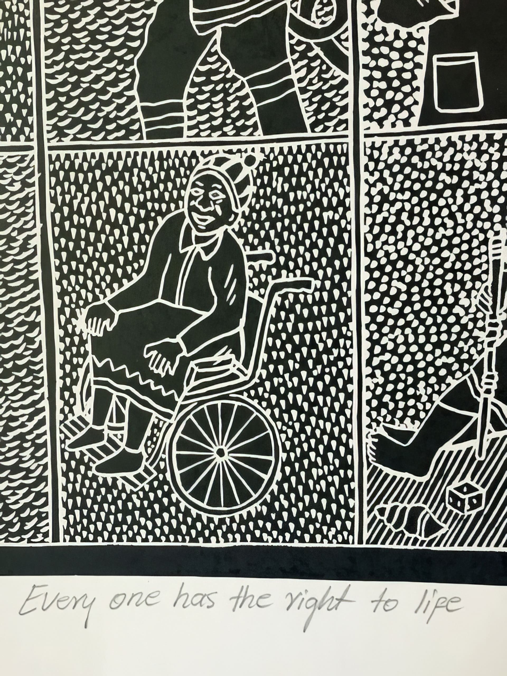 A black-and-white illustration shows a smiling person wearing a hat and shawl seated in a wheelchair. The background is filled with white dots. Below, handwritten text reads, “Everyone has the right to life.”.
