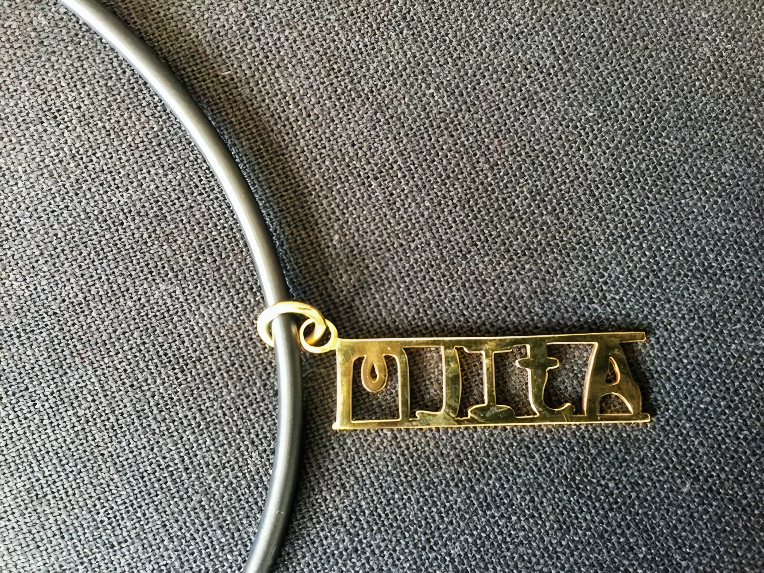 A gold pendant with the name 