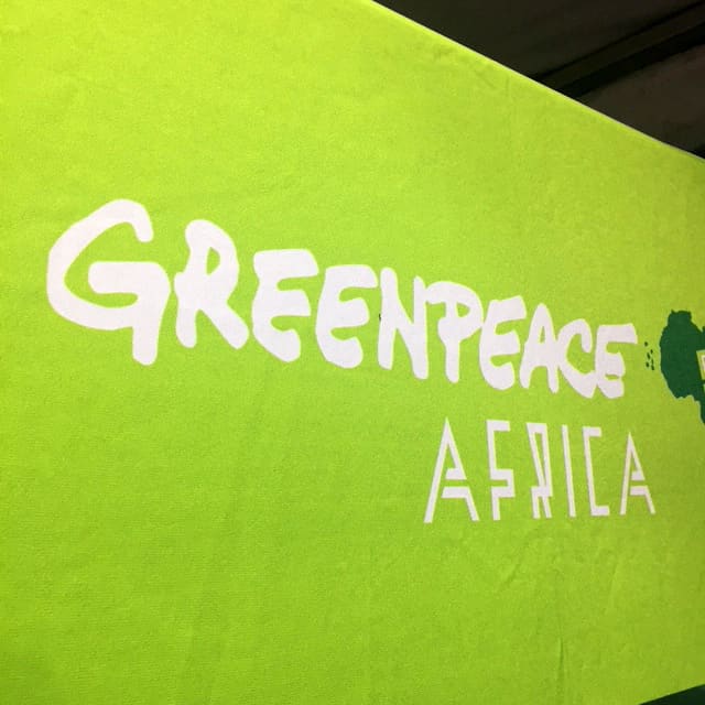 A bright green banner with the white, hand-painted text 