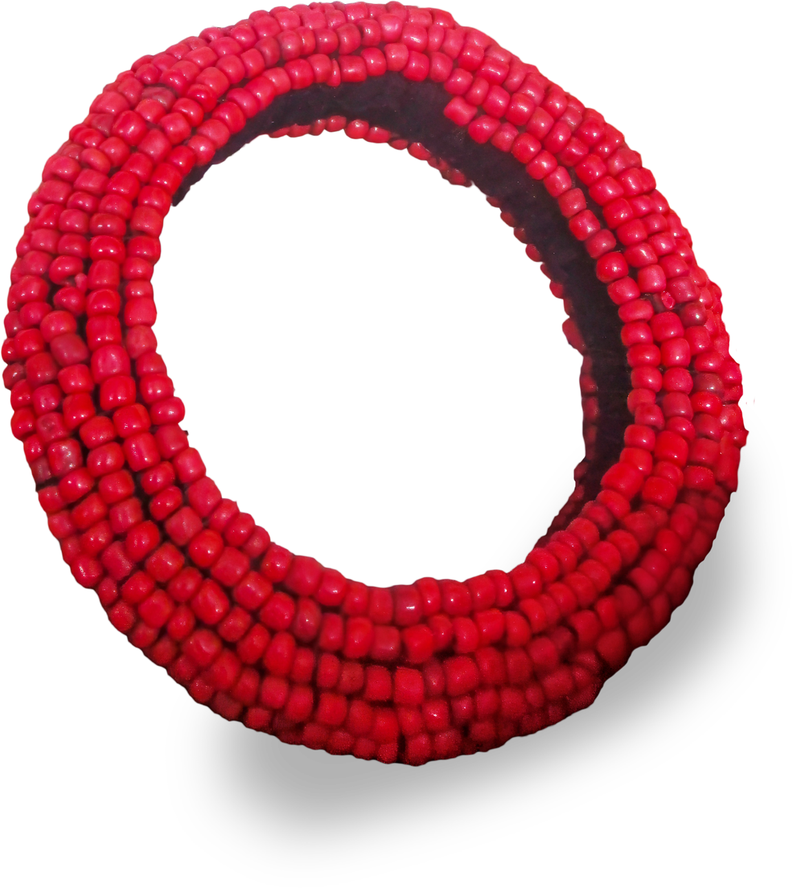 A coiled bracelet made of multiple strands of small, round, shiny red beads. The beads are strung closely together, forming a thick, flexible band. The bracelet’s coils overlap, creating a spiral effect against a white background.