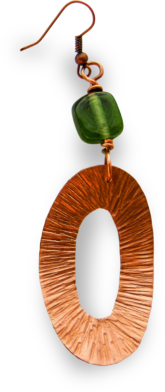 A single earring with a hook, featuring a textured, oval-shaped copper pendant and a small, glossy green bead above it. The copper component has engraved lines radiating outward, while the green bead is square and semitransparent.