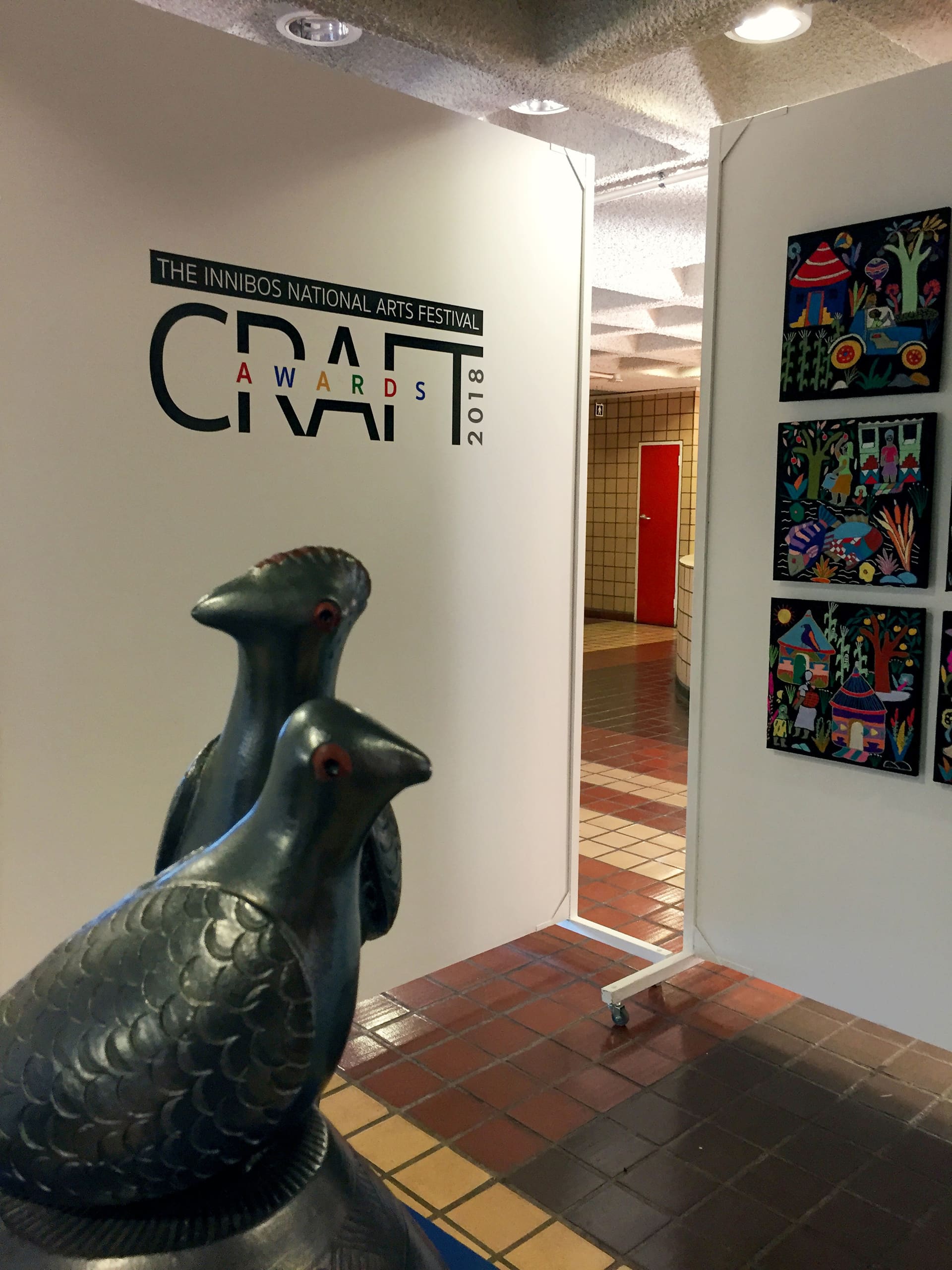 A photo of an art gallery with a wall displaying 
