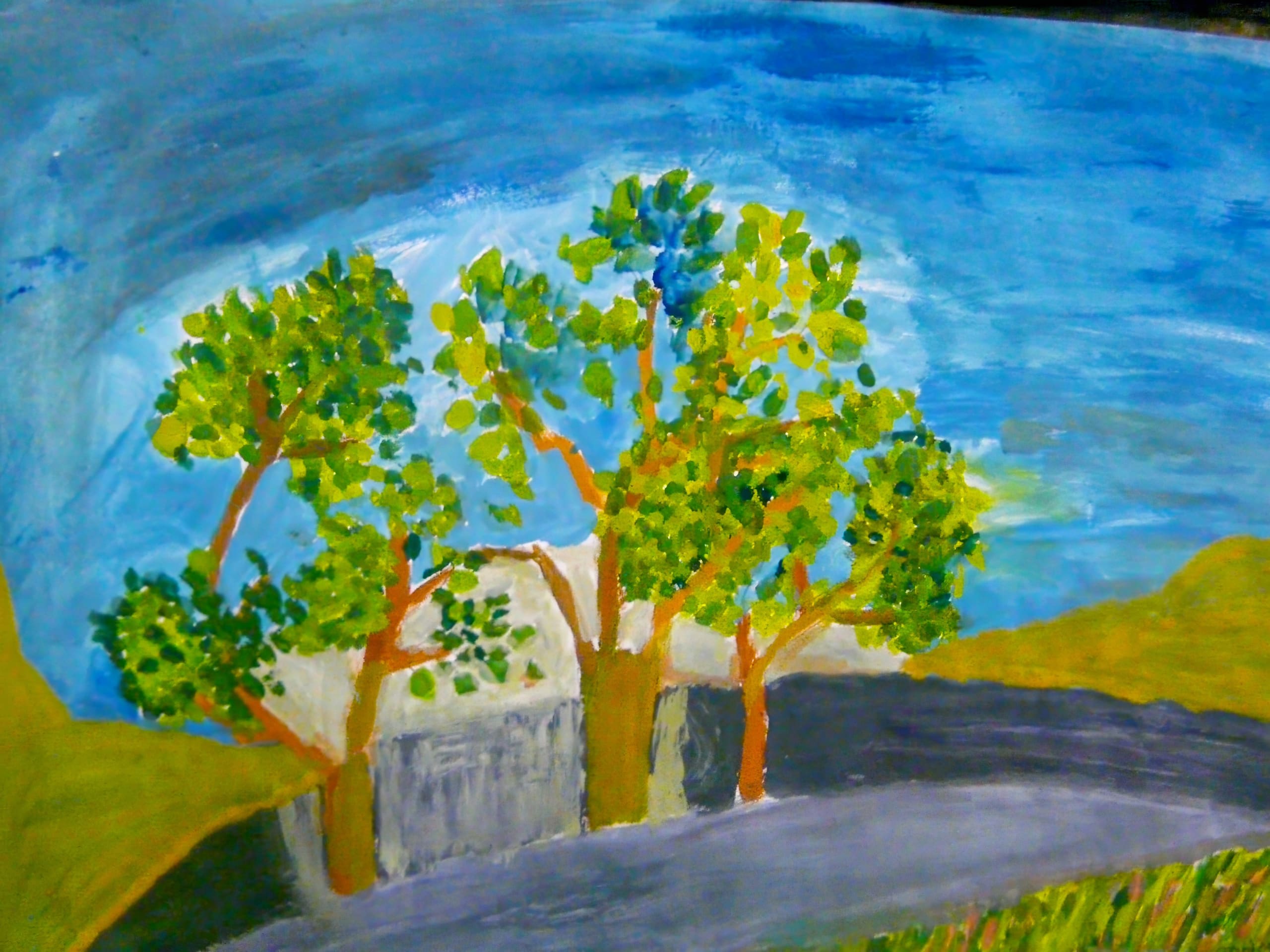 A colourful painting of three leafy trees with brown trunks stands beside a grey road. Behind the trees is a white fence and green hills, under a blue sky with wispy clouds. Bright and lively brushstrokes give the scene a cheerful, impressionistic feel.