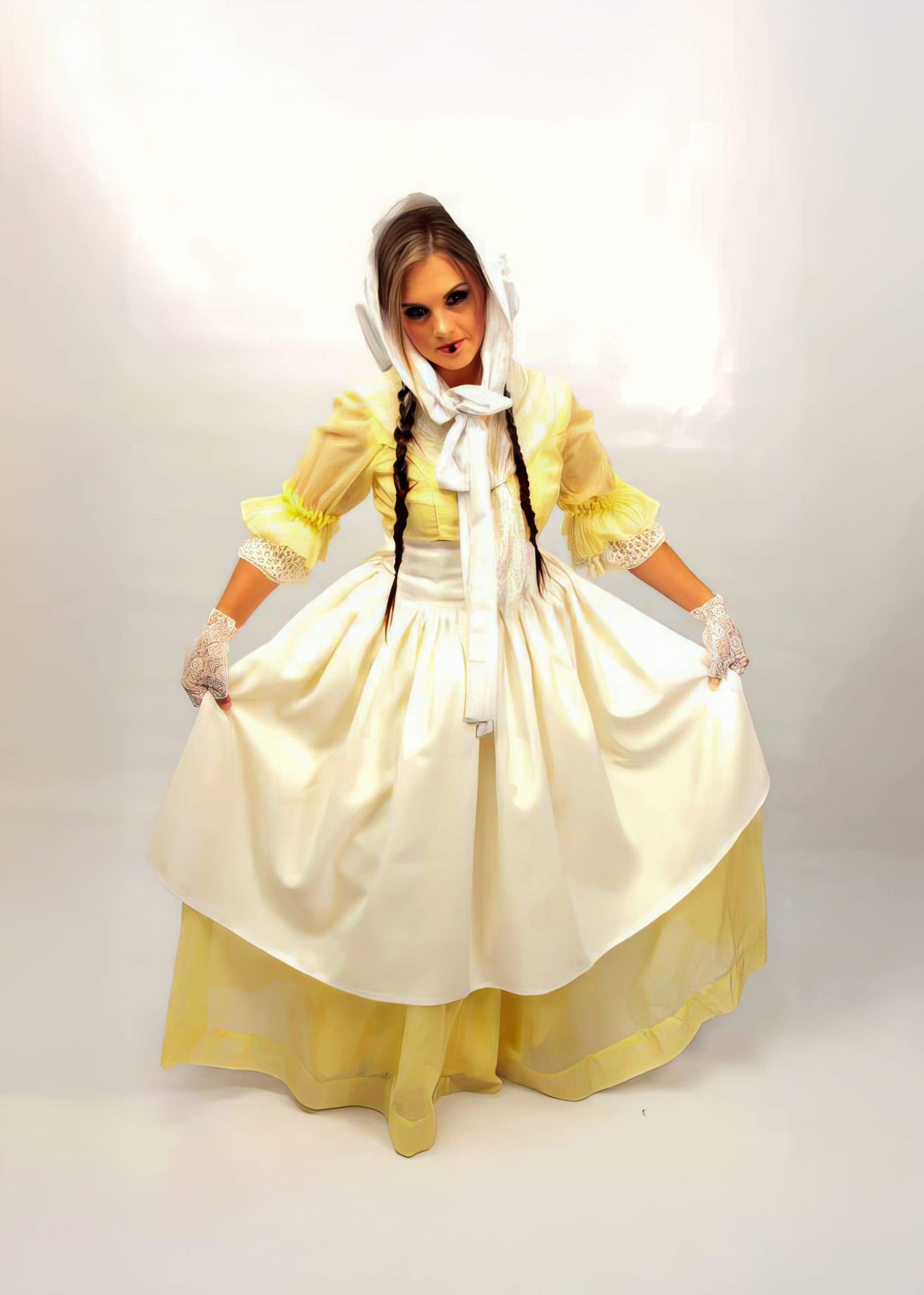 A woman with long brown plaits wears a light yellow and white old-fashioned dress, lace gloves, and a white bonnet. She holds her skirt out to the sides, standing against a plain white background, looking into the camera with a serious expression.