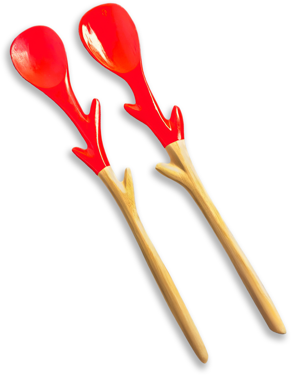 Two wooden salad servers with smooth handles and red, antler-shaped designs extending from the neck to the rounded spoons. The background is solid black, making the red and wood tones stand out vividly.