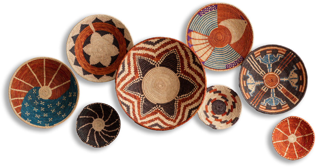 Nine woven baskets with intricate geometric and star patterns in earthy tones of orange, brown, blue, black, and white are arranged on a plain black background. Each basket features unique designs, including stripes, spirals, and concentric circles.