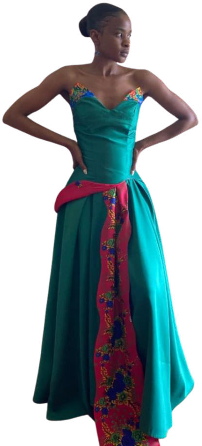 A woman in a teal strapless gown with a heart-shaped neckline, reminiscent of Contra.Joburg elegance. The dress features a pink panel with floral embroidery and a matching accent at the waist. She stands confidently, channelling the Weight of Silence, hair in a sleek bun.
