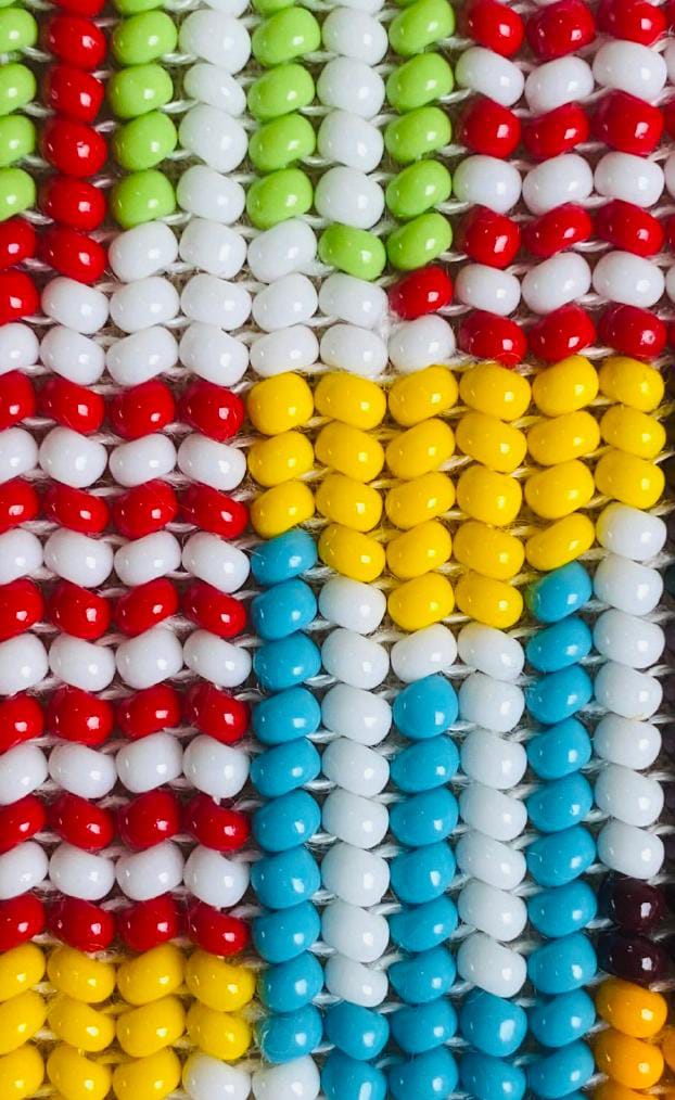 Rows of colourful oval jelly beans are arranged closely together, creating a vibrant, mosaic-like appearance reminiscent of Contra.Joburg’s bold visuals—each colour grouping together in vertical and horizontal lines.