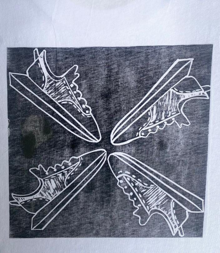 A black and white illustration of four trainers arranged in a square pattern, their toes nearly touching at the centre. The dark, textured background evokes the Weight of Silence, while the trainers are outlined in white.