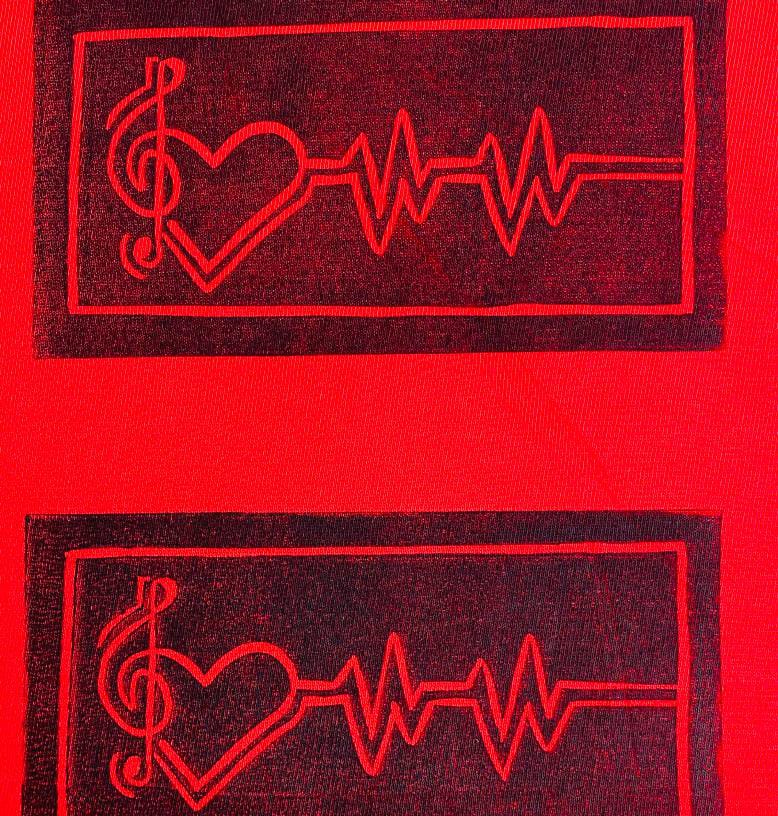 A red fabric shows two identical black rectangular designs. Each features a treble clef, heart shape, and heartbeat line inside, symbolising the connection between music and love—perfect for any fan of Contra.Joburg or Weight of Silence.