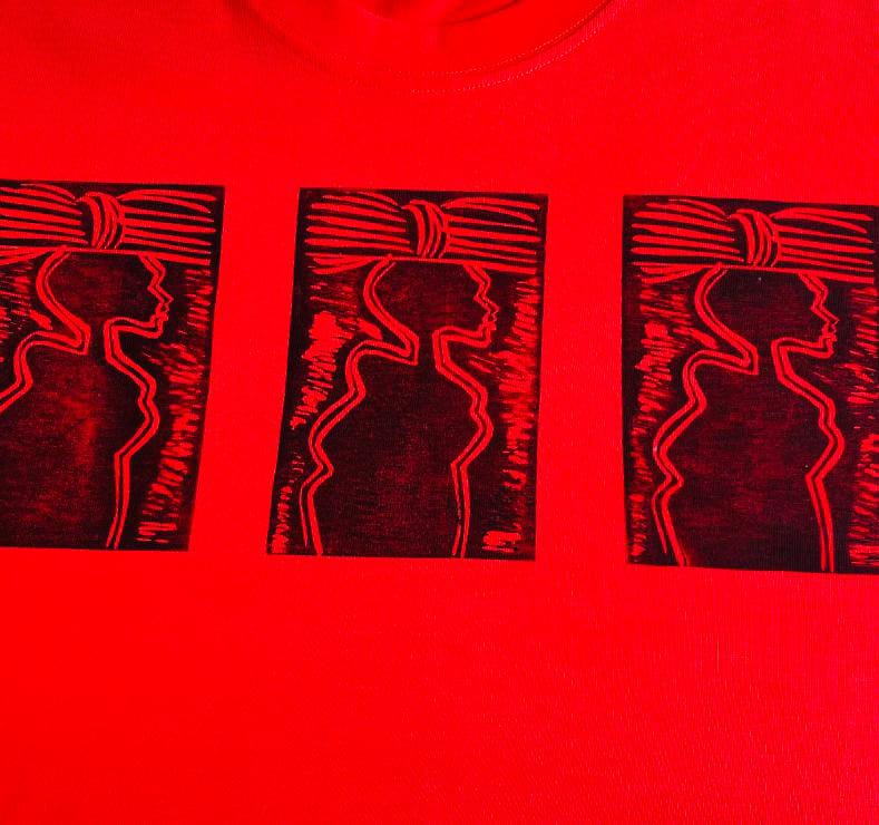 A red shirt from Contra.Joburg features three identical black rectangular prints, each showing the stylised profile silhouette of a person wearing a headwrap with horizontal lines, facing left. The repeated graphic stands out sharply against the bright red fabric.