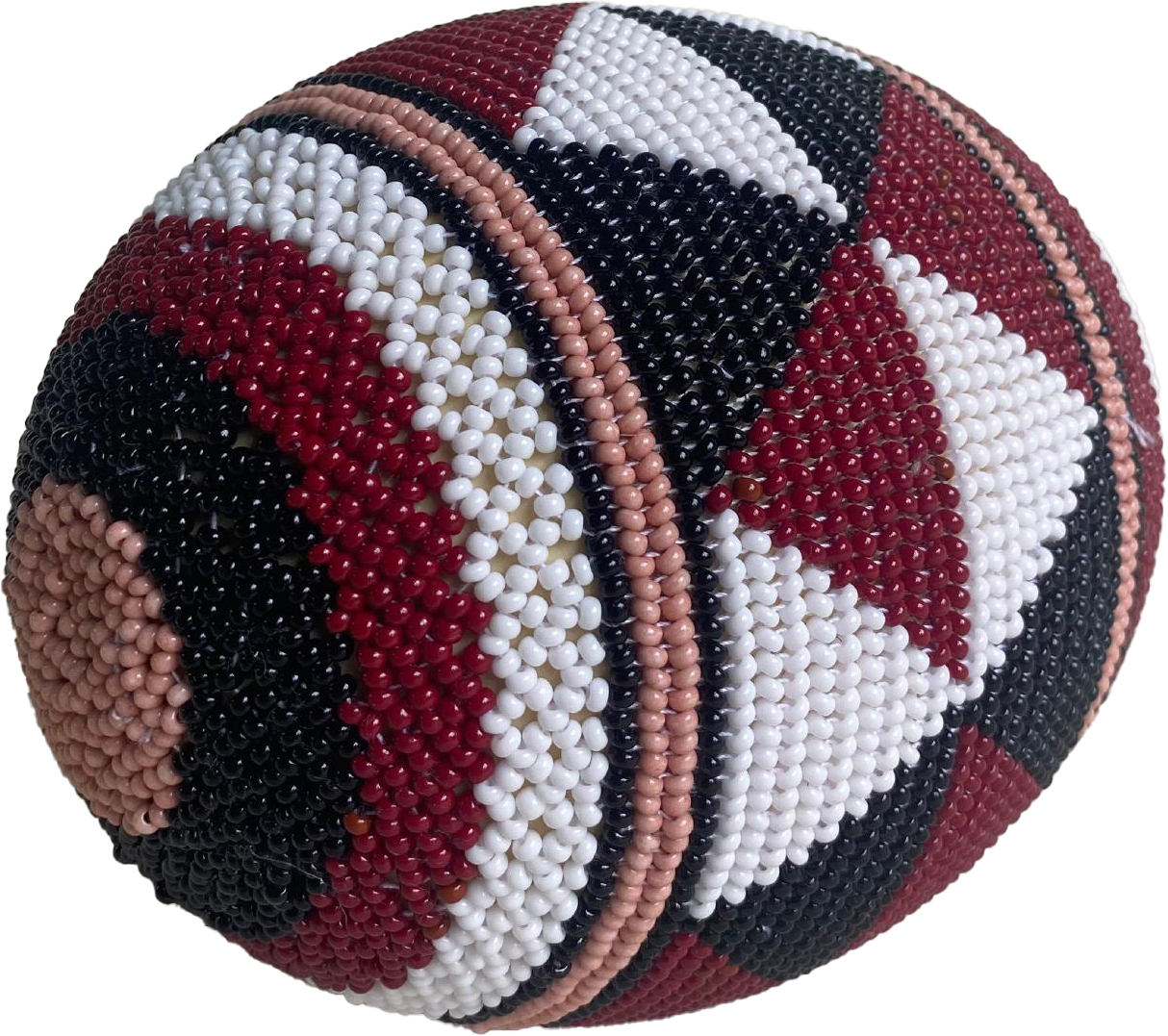 A round object from Contra.Joburg, decorated with tiny glass beads in geometric patterns. The design features triangles, stripes, and concentric circles in black, white, maroon, peach, and tan for a textured Weight of Silence effect.