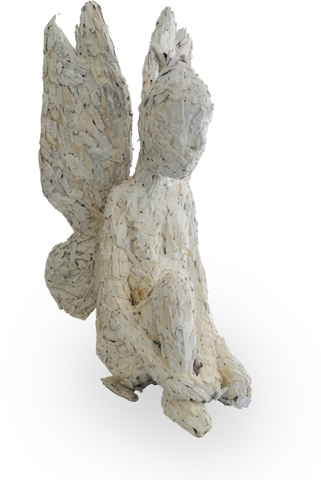 A textured sculpture titled The Weight of Silence, featured at Contra.Joburg, depicts a kneeling human figure with wings, crafted from overlapping pale wood. With a featureless face and rough, layered surfaces, it evokes quiet introspection.