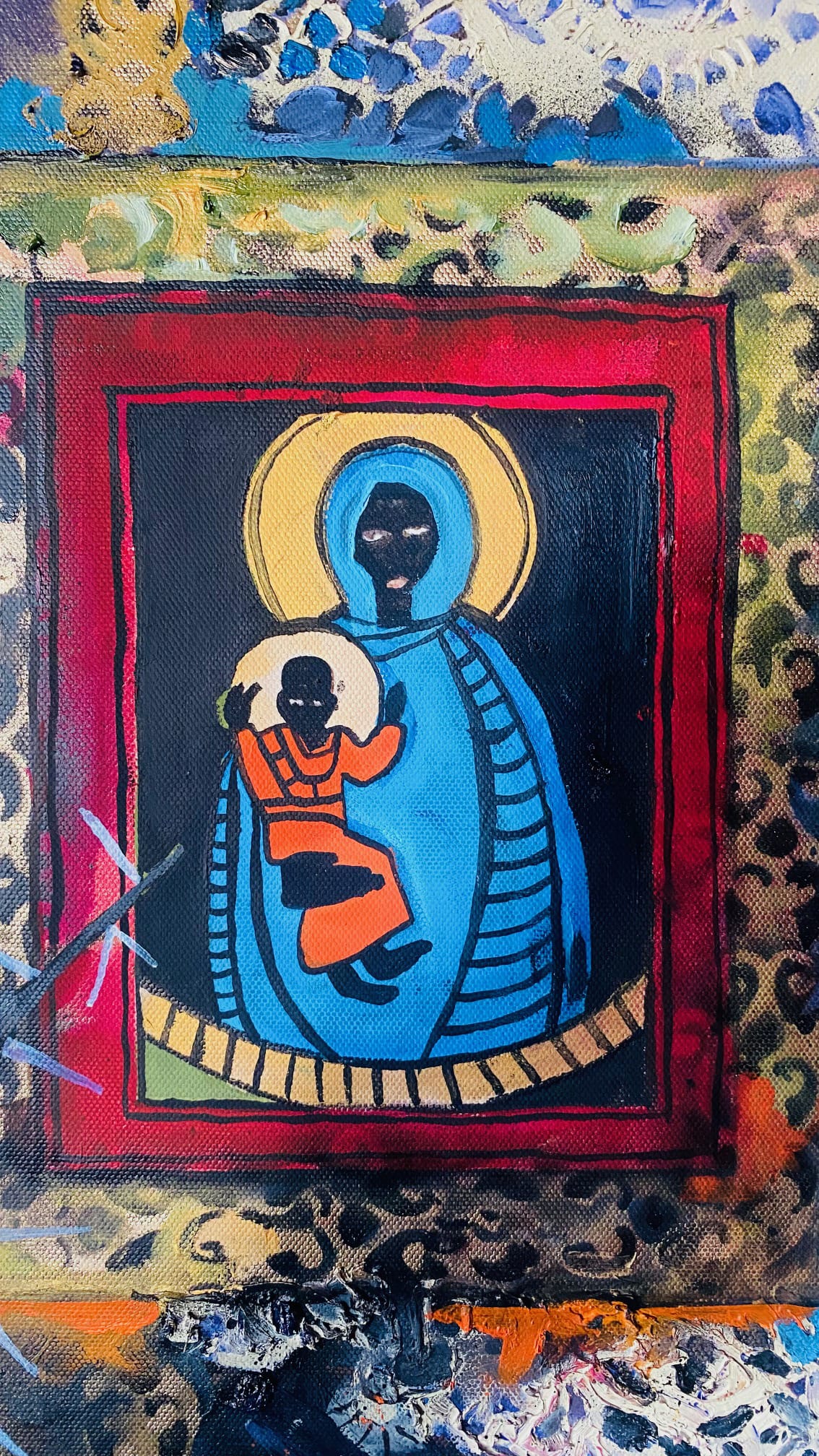 A colourful painting depicts a stylised Black Madonna and Child with haloes. The Madonna wears a blue robe with yellow accents; the child is in orange. Both have dark faces and hands. The background is framed with vibrant patterns in red, gold, blue, and black.